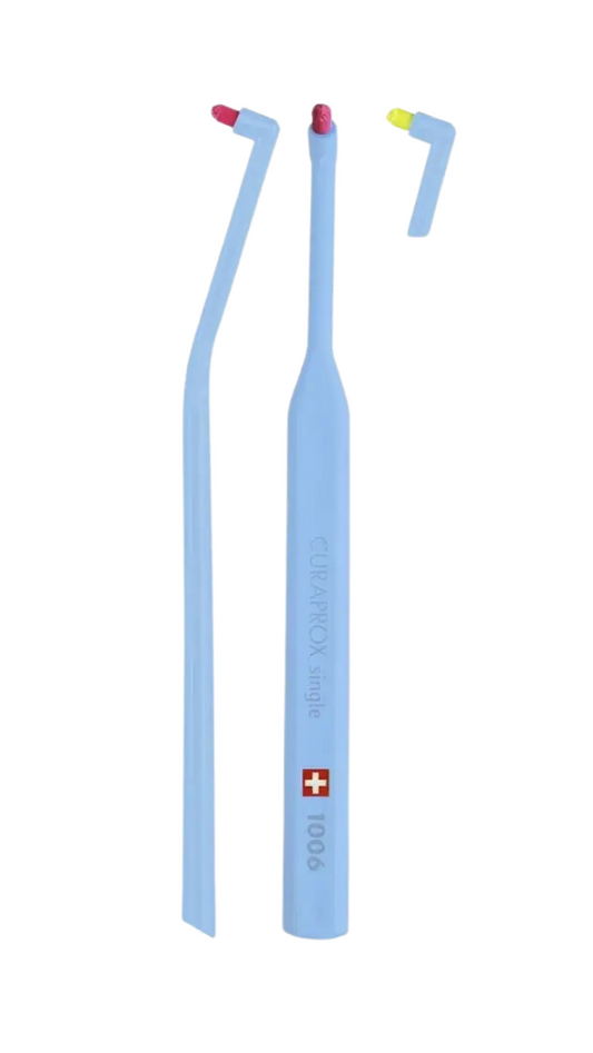 A selection of Curaprox dental brushes with single and sulcular design, displayed in a range of colors.