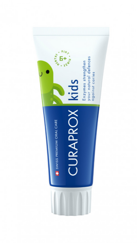 A tube of Curaprox kids' toothpaste with a cartoon character on the packaging, indicating it is designed for children.