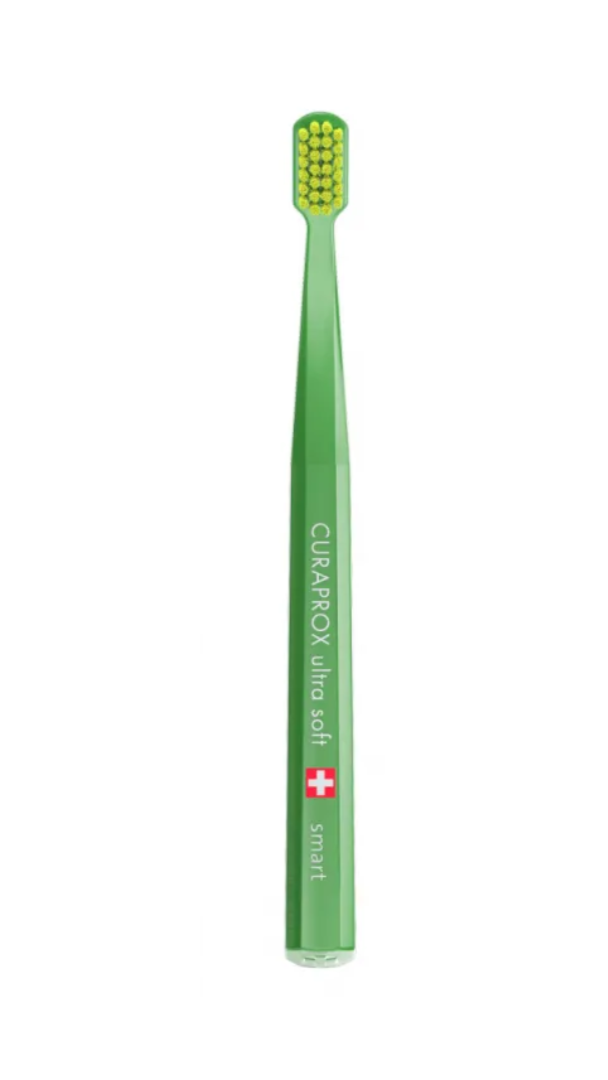 Green toothbrush with Curaprox branding on a white background