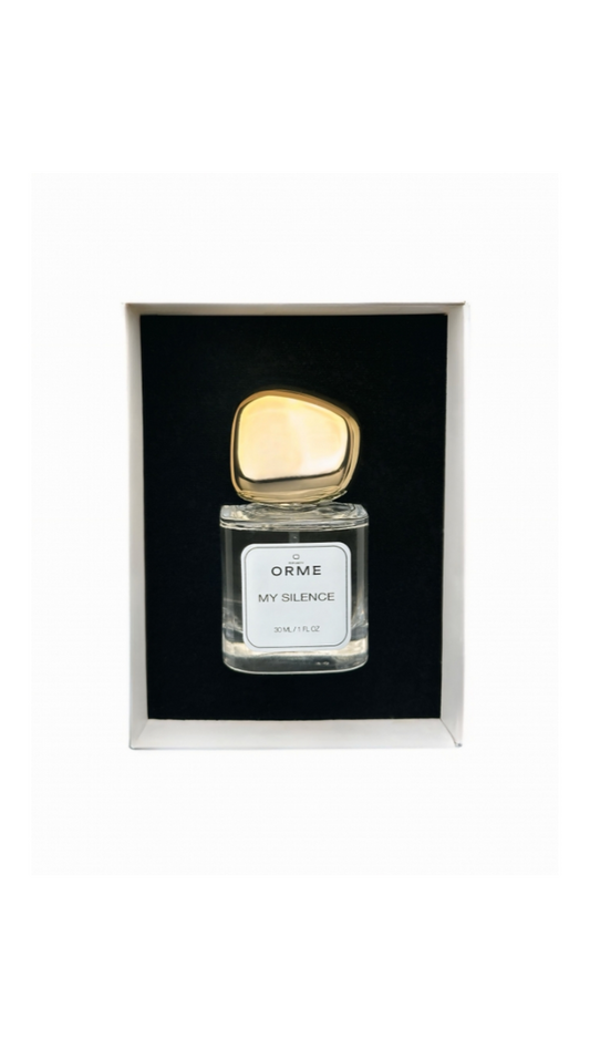 Perfume bottle with gold cap in a black box on a white background