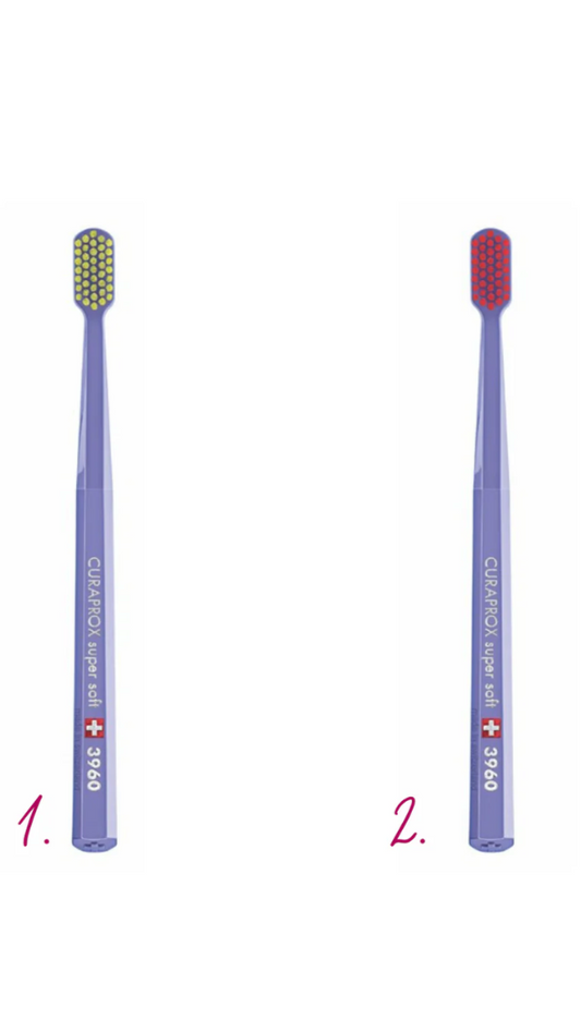 Two purple toothbrushes with different bristle colors on a white background