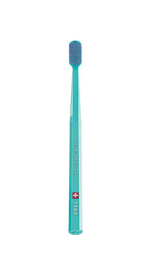 A set of six Curaprox CS 1560 toothbrushes in various colors, featuring soft, round-tipped bristles and a medium handle.