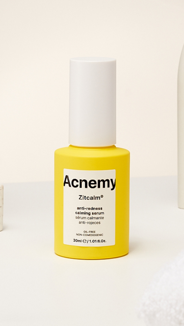 Acnemy Zitcalm serum bottle on a white surface with a neutral background