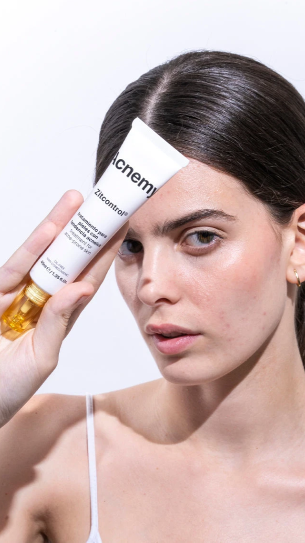 Woman holding a skincare product with a white background