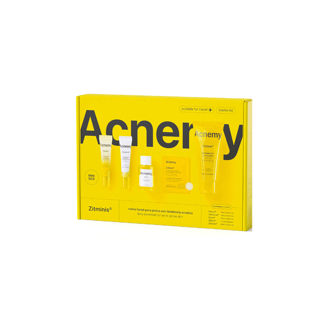 Acne treatment kit with yellow packaging and visible skincare products on a white background