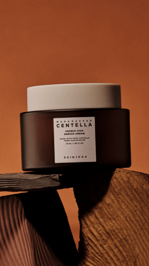 Skintox Centella Probioticica Enrich Cream jar on a textured surface with a brown background