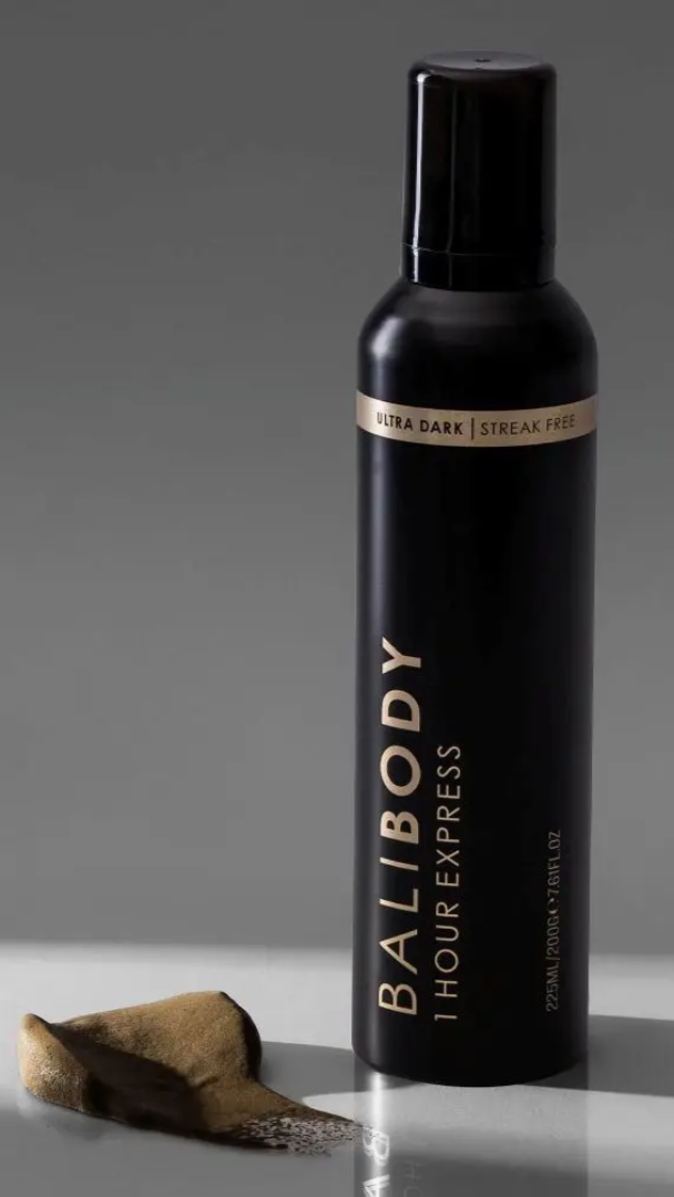 Black bottle of Balibody hair product on a gray background