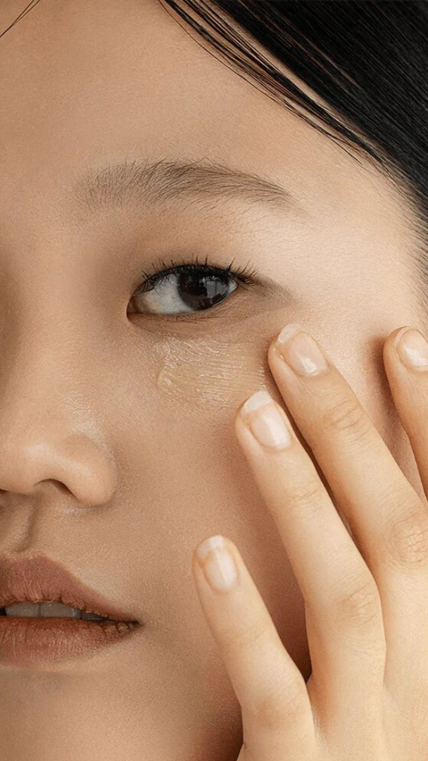 Close-up of a person applying makeup to their face