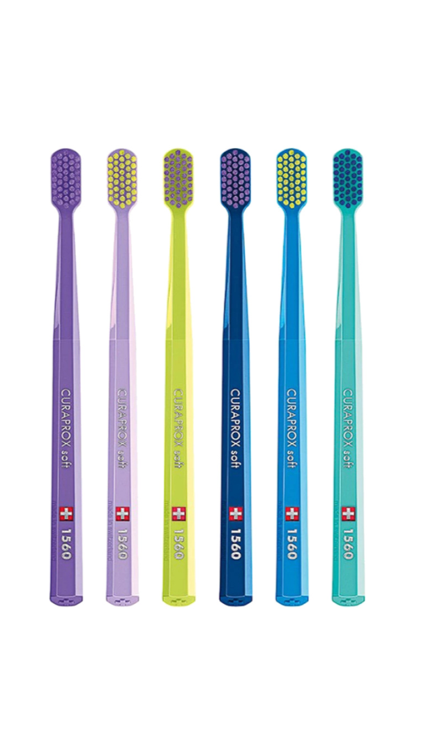 Set of six colorful toothbrushes with visible brand logo on a white background