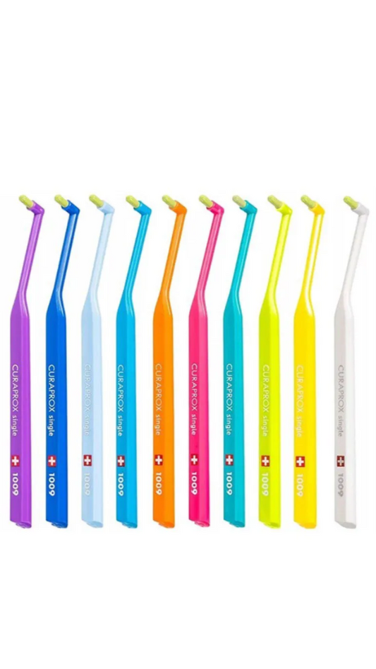 Set of colorful dental tools with visible brand logo on a white background