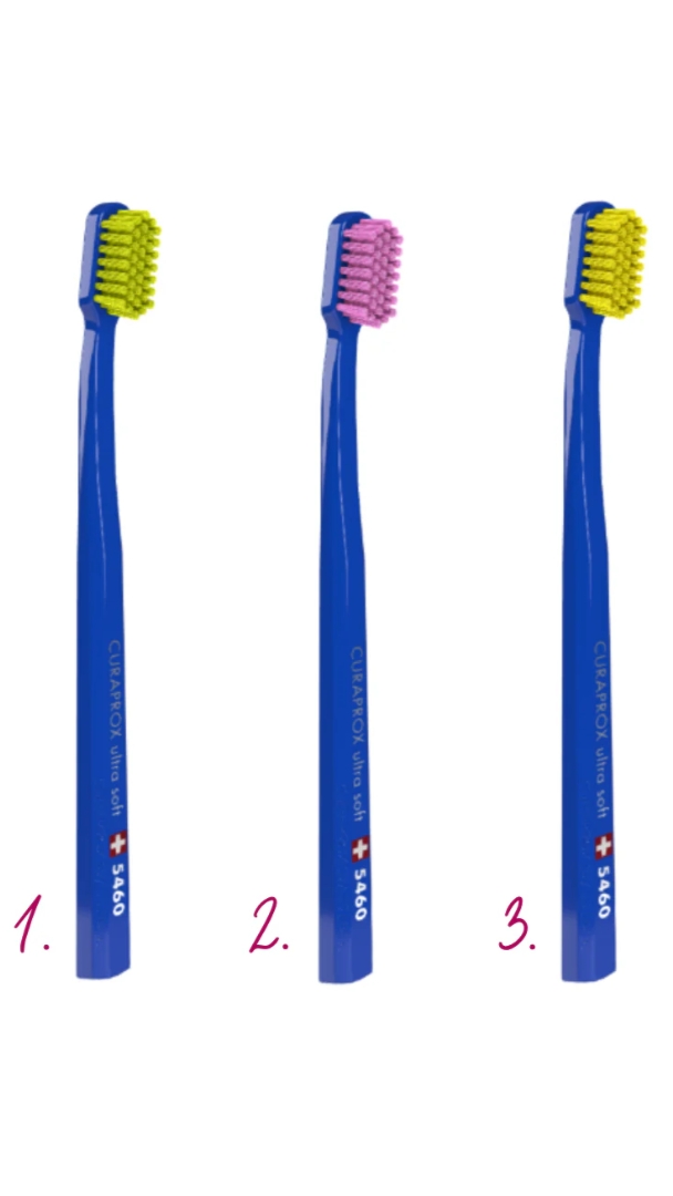 Three blue toothbrushes with different bristle colors on a white background