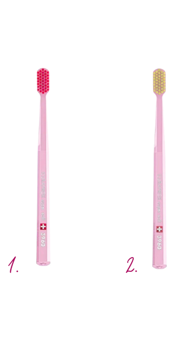 Two pink toothbrushes with different bristle designs on a white background