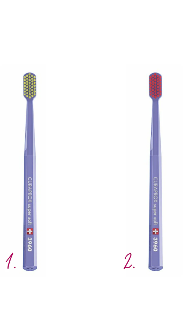 Two purple toothbrushes with different bristle colors on a white background