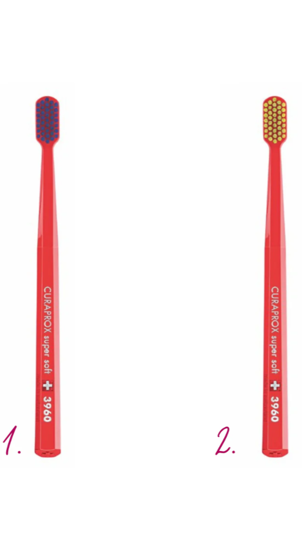 Two red toothbrushes with different bristle patterns on a white background