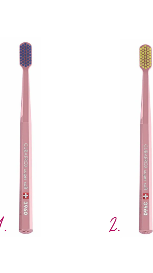 Two pink toothbrushes with different bristle colors on a white background
