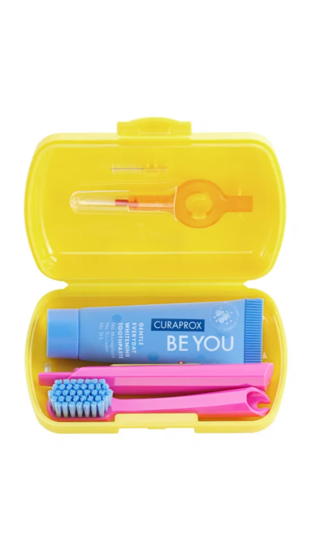 Yellow travel case with toothbrush, toothpaste, and dental floss on a white background