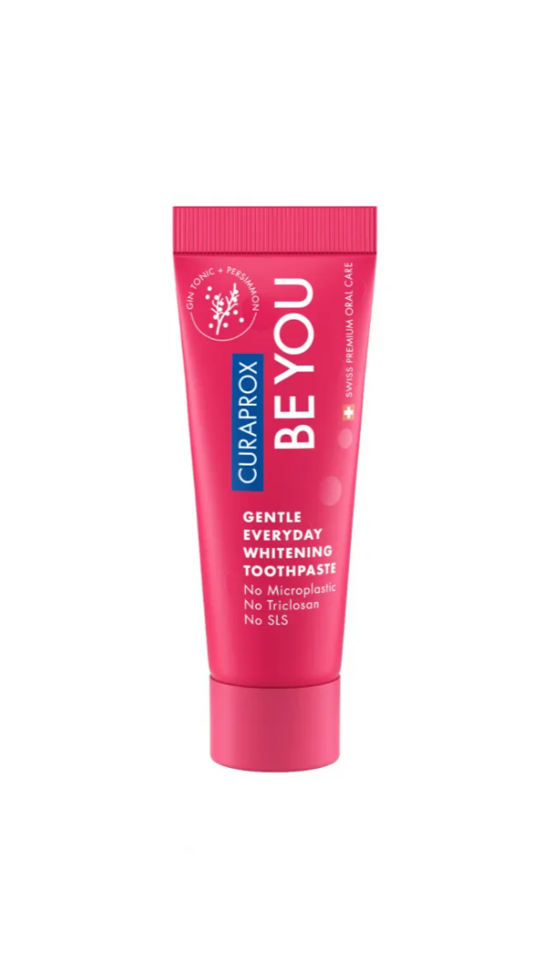 Pink toothpaste tube with 'Curaprox BE YOU' branding on a white background
