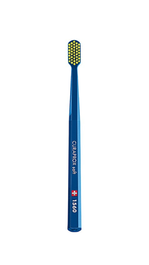A set of six Curaprox CS 1560 toothbrushes in various colors, featuring soft, round-tipped bristles and a medium handle.